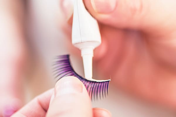 Apply glue to false lashes